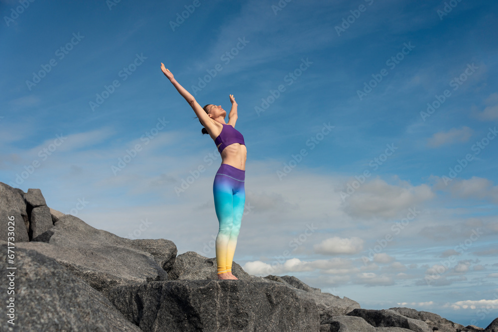 Woman with arms wide open standing on a mountain rocks with hands up feel relax or happy or freedom travel. Success and winner concept. Woman with arms wide open standing on a mountain rocks with hands up feel relax or happy or freedom travel. Success and winner concept.