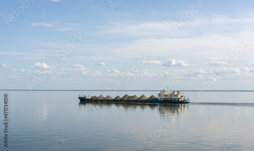 A dry cargo barge sails on Lake Beloe in complete calm © Игорь Кляхин