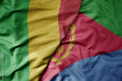 big waving national colorful flag of mali and national flag of eritrea .