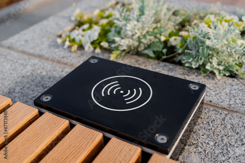 Charging pad for smartphones in the park in summer