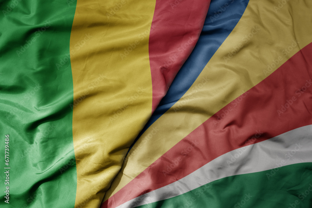 big waving national colorful flag of mali and national flag of seychelles .