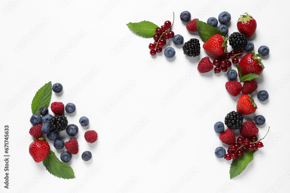 Many different fresh berries and mint leaves on white background, flat lay. Space for text Many different fresh berries and mint leaves on white background, flat lay. Space for text