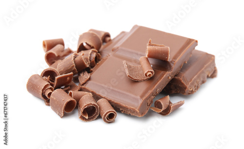 Pieces of tasty chocolate bar and shavings isolated on white