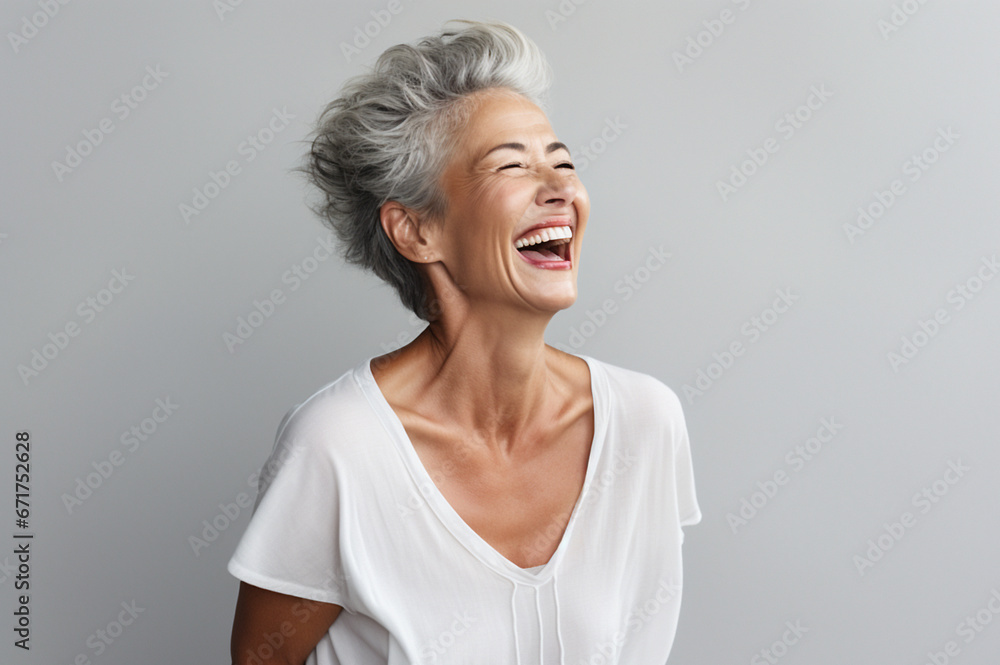 Portrait of attractive elderly happy laughing woman with gray hair over gray background. AI generated Portrait of attractive elderly happy laughing woman with gray hair over gray background. AI generated