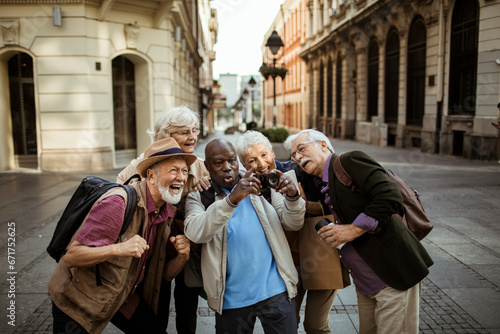 Group of diverse seniors capturing the city with a camera photo