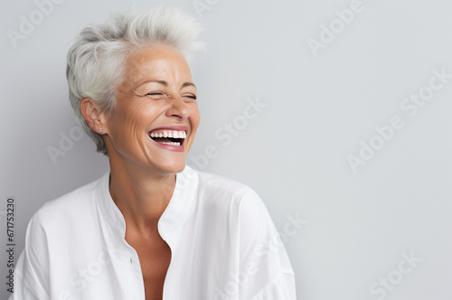 Portrait of attractive elderly happy laughing woman with gray hair wearing sunglasses over gray background. AI generated