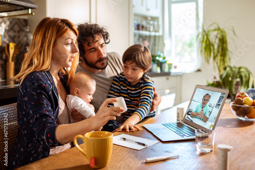 Family with young children attending a virtual medical consultation