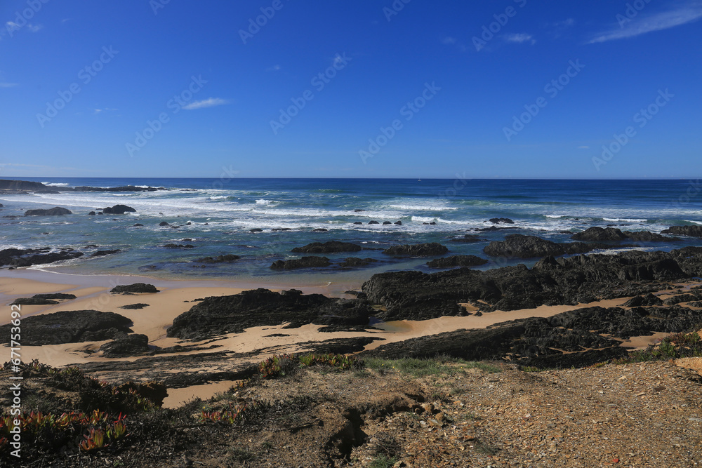 Beautiful Almograve beach with black basalt rocks in Portugal Beautiful Almograve beach with black basalt rocks in Portugal