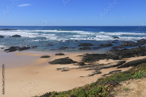 Beautiful Almograve beach with black basalt rocks in Portugal