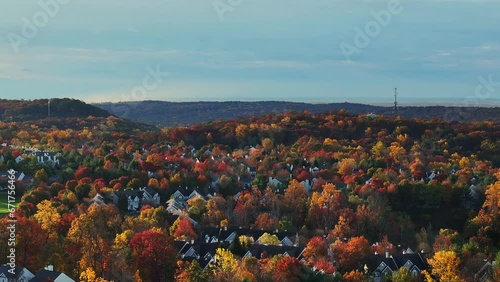 Residential homes along a fall colored mountain
