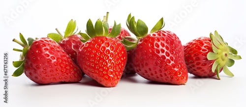 Close up of fresh strawberries against a white backdrop