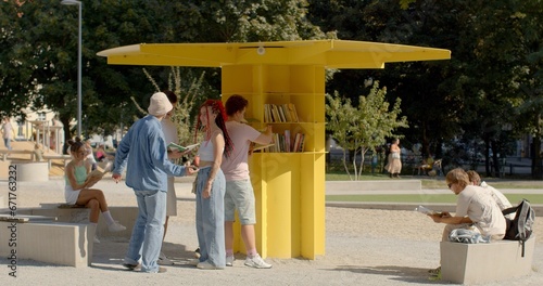 People rest in park, reading books. An open public library is a community resource that provides access to a wide range of books and other reading materials for free.