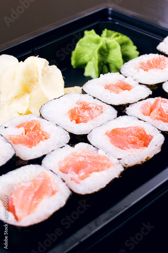 Rolls with salmon in a container close up