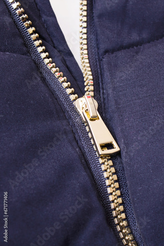 Metallic yellow zipper on a black jacket