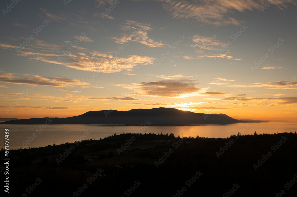 Aerial view of a beautiful sunset over Orcas Island in the Salish Sea area of the San Juan Island archipelago.  Looking from Lummi Island across Rosario Strait the sun sets behind Mt. Constitution.