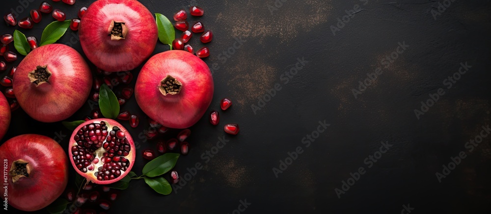 View from above of pomegranates against a backdrop of dark metallic black