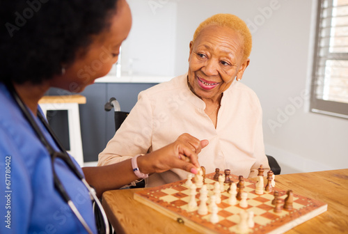 Nurse playing chess with a senior patient after a healthcare consultation in nursing rehabilitation center. Board game, conversation and female caregiver bonding with elderly woman in retirement home