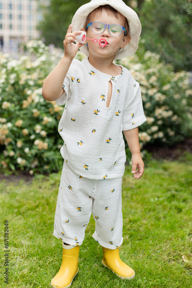 cute happy child 4 years old blowing soap bubbles outdoors cute happy child 4 years old blowing soap bubbles outdoors