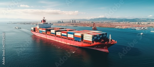 Top aerial view of moving container ship in open ocean symbolizing import export industry