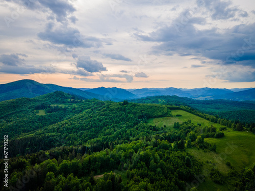 Texture of green tree forest view from above, Beautiful sunrise over the mountains of Carpathians