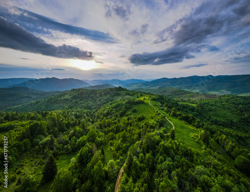 Green tree forest view from above, Beautiful sunrise over the mountains of Carpathians, valley