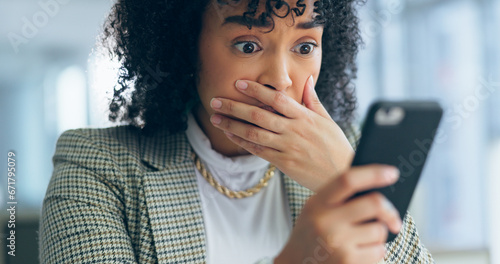 Business woman, reading phone and shocked for social media post, news or marketing error in office. Young african employee confused, surprise and stress on mobile for scam, mistake or wrong email photo