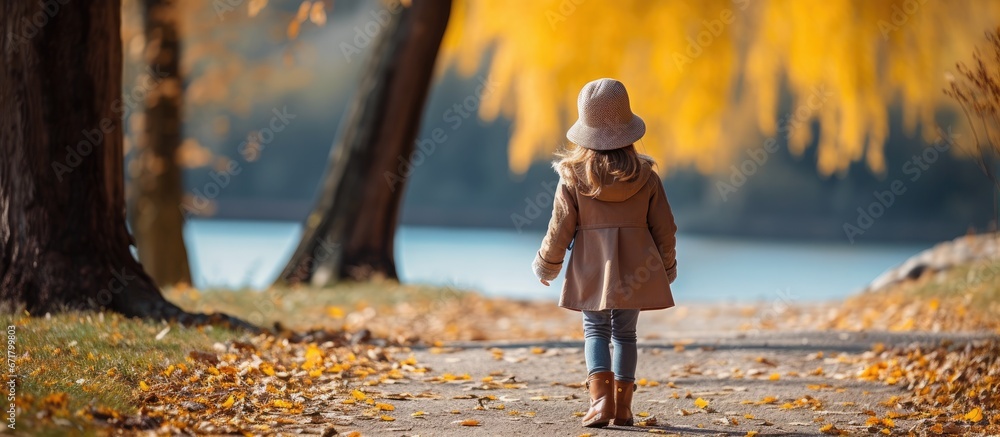 Adorable young girl strolling through a park