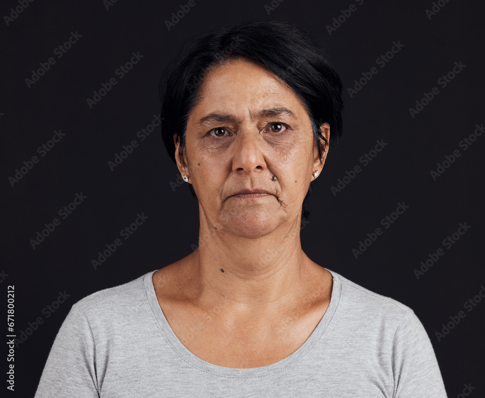 Senior woman, portrait and mental health, depression and crisis with abuse isolated on black background. Sad, angry and anxiety with depressed female person, serious face and grief in a studio Senior woman, portrait and mental health, depression and crisis with abuse isolated on black background. Sad, angry and anxiety with depressed female person, serious face and grief in a studio