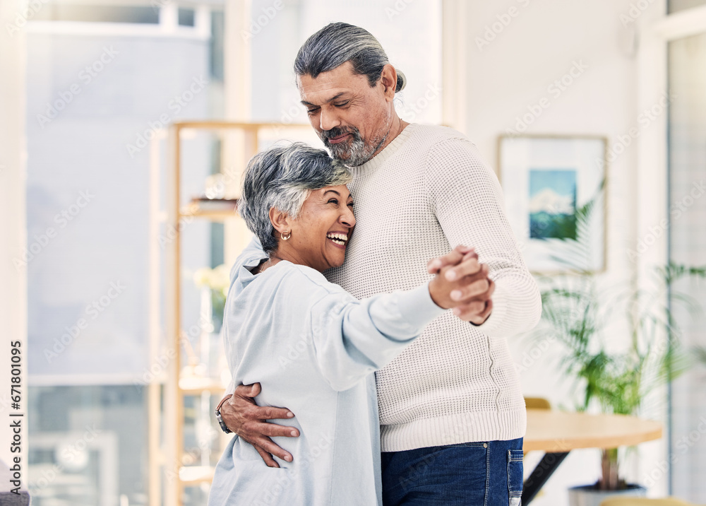 Obraz premium Happy senior couple, holding hands and dance in living room for love, care or bonding together at home. Elderly man and woman hug enjoying quality time, retirement or celebration for anniversary