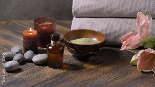Beauty spa treatment with oils, laminaria algae in bowl and candles on dark background photo
