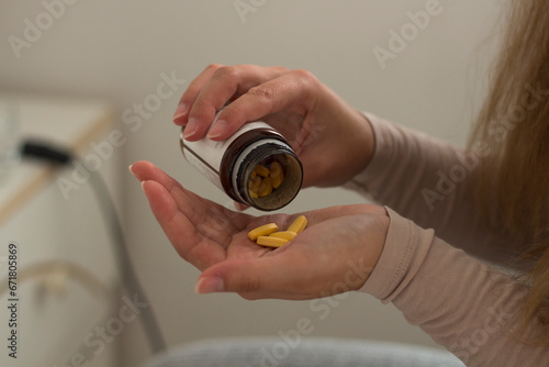 Woman holding medicines bottle and pouring some pills on another hand for treatment medication