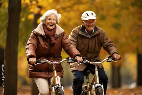 Seniors enjoying a bike ride in the serene park at autumn