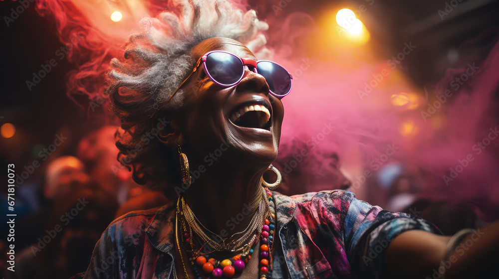 Stylish elderly African American woman in fashionable glasses dances funny in a nightclub. Senior woman having fun in neon lighting. Stylish elderly African American woman in fashionable glasses dances funny in a nightclub. Senior woman having fun in neon lighting.