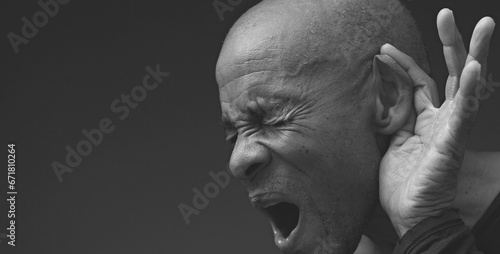 Billede på lærred deaf man suffering from deafness and hearing loss on grey black background with