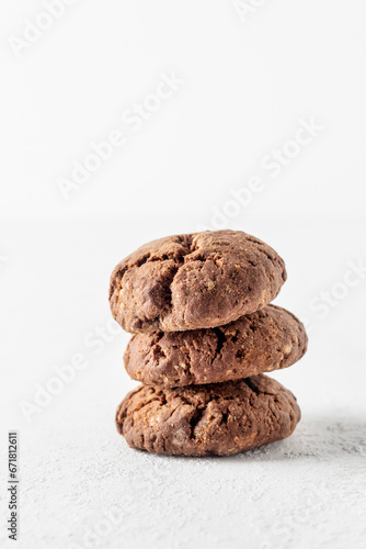 Stack of chocolate brownie cookies with crack on white background. Homemade crinkle cookies