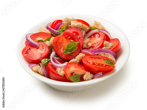 Italian salad Panzanella tomatoes pieces of bread and onions in a salad bowl isolated on white background.