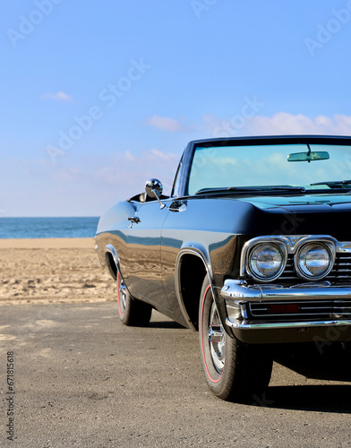 restored old convertible car at the beach photo