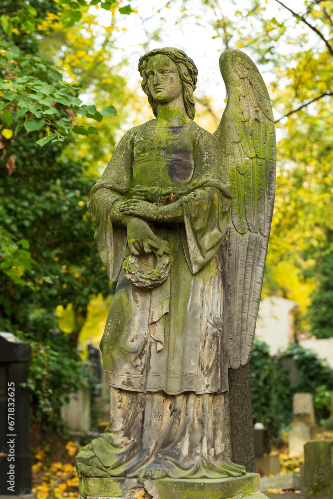 Historic Statue on the autumn mystery old Prague Cemetery, Czech Republic
