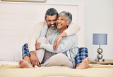 Hug, happy or old couple in bed to relax, enjoy romance or morning time together at home in retirement. Embrace, senior woman or funny elderly man laughing or bonding with love, support or smile