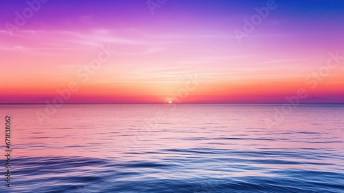 Tranquil sunset over the ocean  with a serene color gradient of purple  blue  orange  and pink. The warm sun reflects on the calm water  creating a peaceful and vibrant atmosphere
