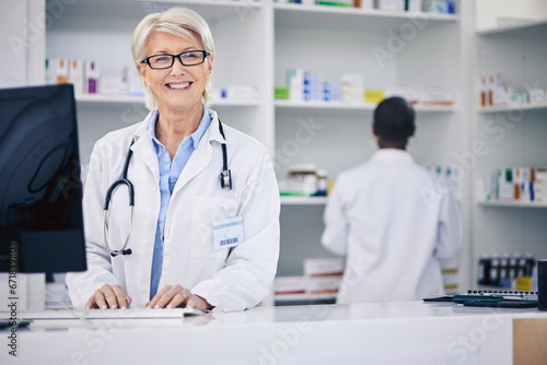 Pharmacist  portrait and happy senior woman on computer in pharmacy  drugstore or shop. Smile  medical professional and face of doctor on internet for telehealth  healthcare and research for medicine