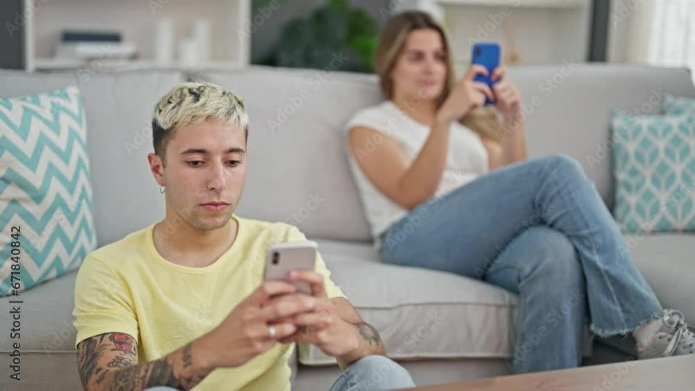 Beautiful couple using smartphones at home Beautiful couple using smartphones at home