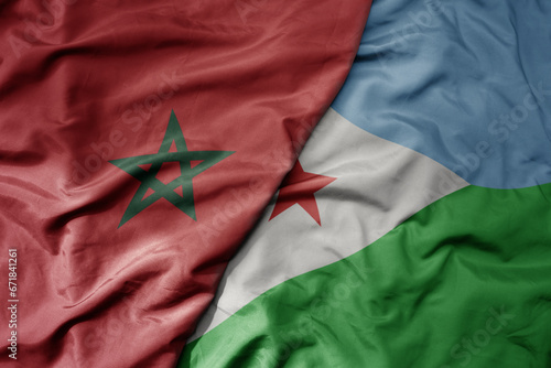 big waving national colorful flag of morocco and national flag of djibouti .