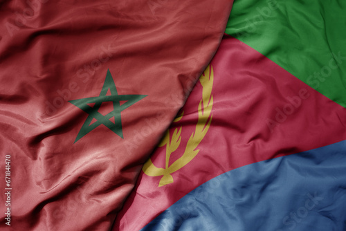 big waving national colorful flag of morocco and national flag of eritrea .