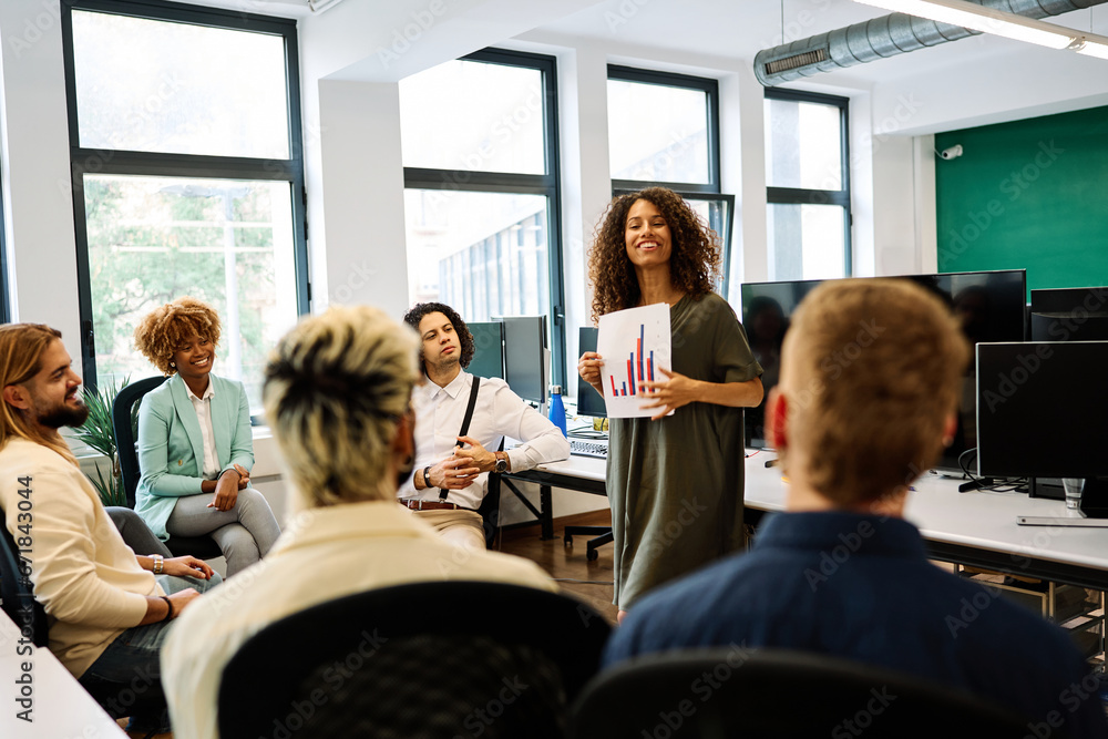 Fototapeta premium Woman showing graphics during a meeting in a coworking