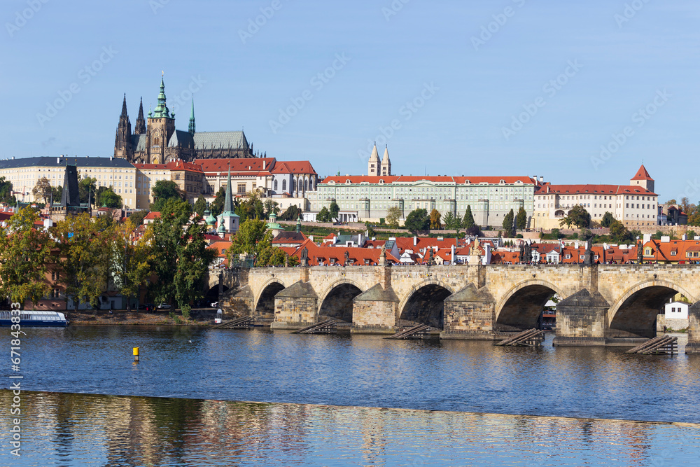 Obraz premium Autumn colorful Prague Lesser Town with gothic Castle above River Vltava in the sunny Day, Czech Republic