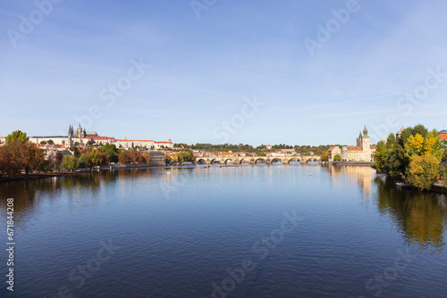 Autumn colorful Prague Lesser Town with gothic Castle above River Vltava in the sunny Day, Czech Republic © Kajano