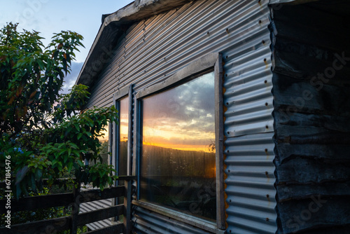 Wallpaper Mural The Sunset Reflection off of a Vacation Cabin That Has A Large Bay Window Torontodigital.ca