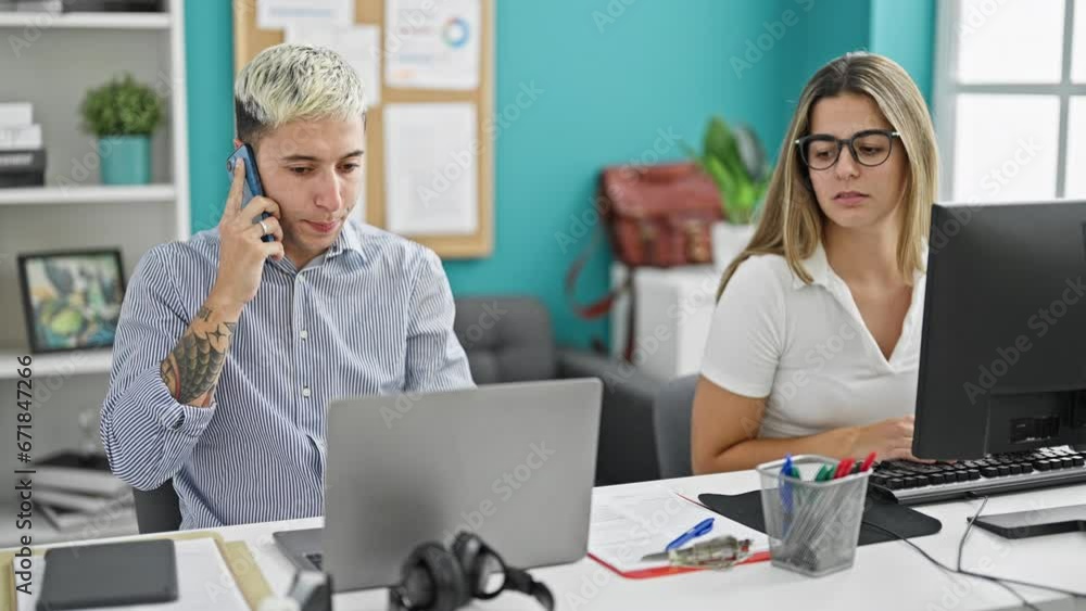 Two workers man and woman working together talking on smartphone at the office Two workers man and woman working together talking on smartphone at the office