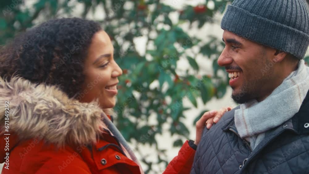 Couple wearing coats and scarves meeting for cold walk in misty autumn or winter countryside - shot in slow motion Couple wearing coats and scarves meeting for cold walk in misty autumn or winter countryside - shot in slow motion